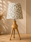 Tripod Table Lamp in warm natural wood finish, part of the Nilvara selection
